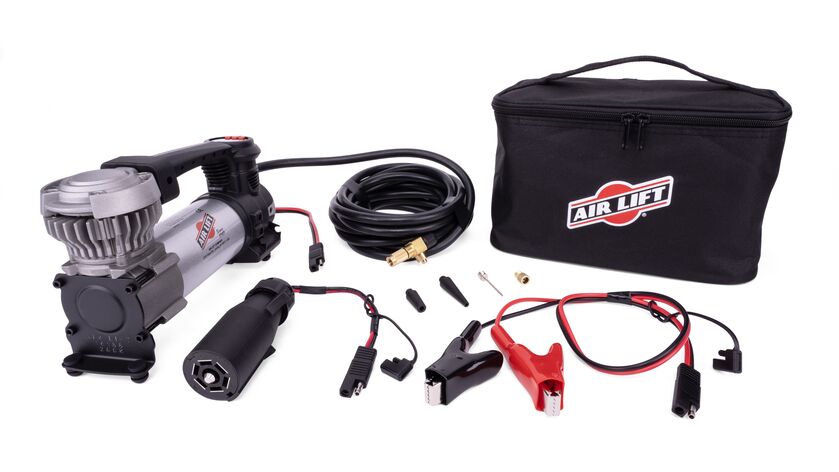 Air Lift’s Digital Portable Compressor is a portable compressor with a digital gauge showing the pressure reading, a 7-way power adapter, and an alligator-style battery clamp power adapter. It can inflate air springs, tires, and toys.