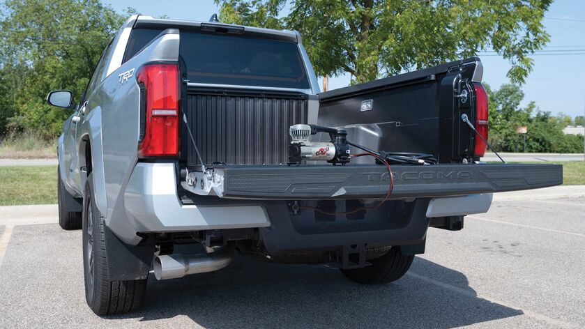 Air Lift’s Digital Portable Compressor is a portable compressor with a digital gauge showing the pressure reading, a 7-way power adapter, and an alligator-style battery clamp power adapter. It can inflate air springs, tires, and toys.