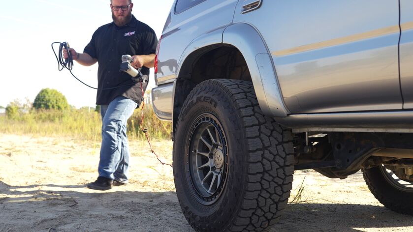 Air Lift’s Digital Portable Compressor is a portable compressor with a digital gauge showing the pressure reading, a 7-way power adapter, and an alligator-style battery clamp power adapter. It can inflate air springs, tires, and toys.